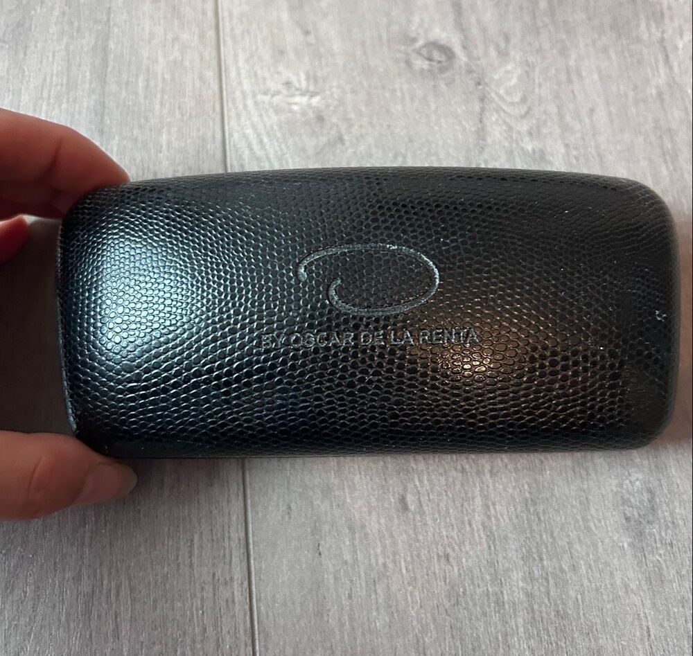 Oscar de la Renta black sunglasses case with the red interior